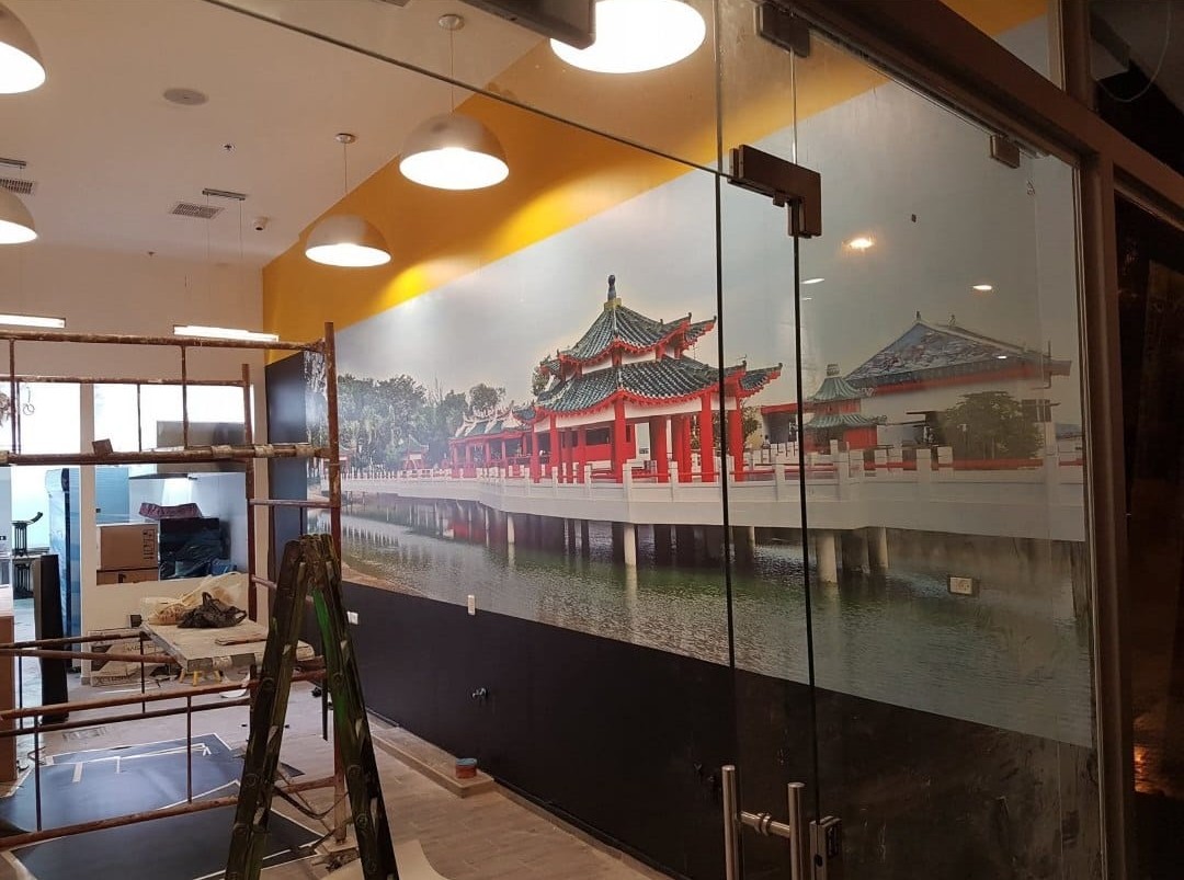 A large architectural scene decorates a restaurant wall.